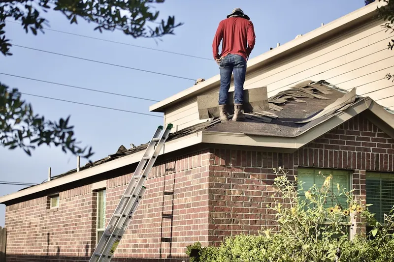 Professional roofer working on a residential roof in Foxwood
